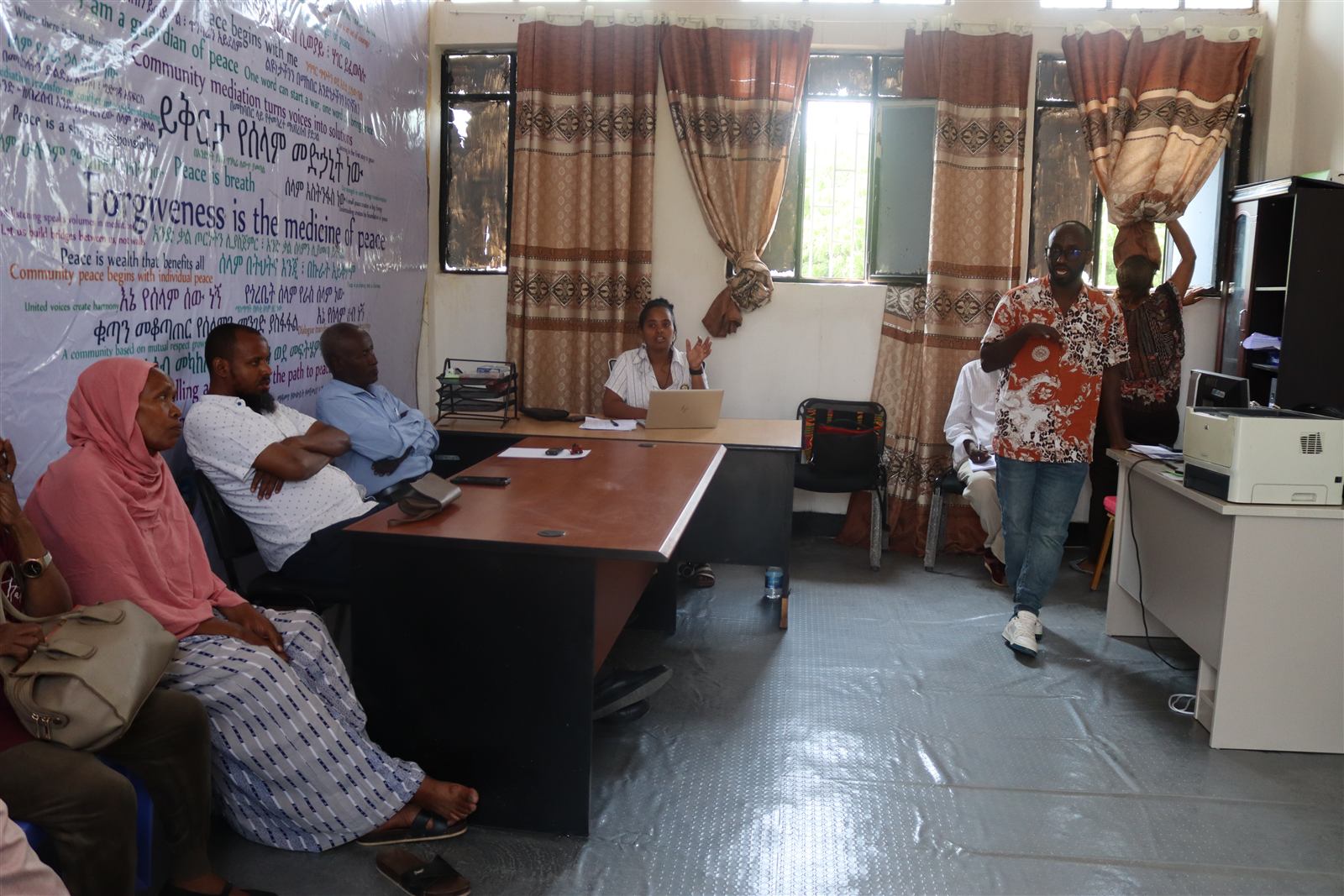 A hub member addressing the room mid-meeting