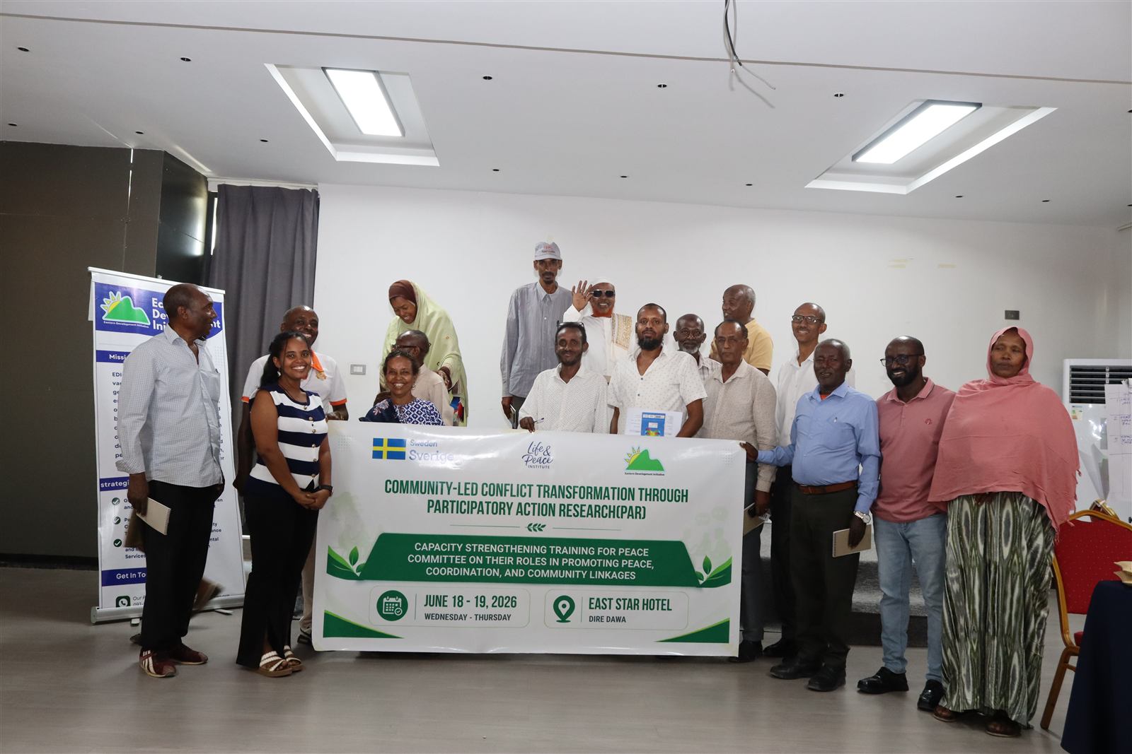 Peace committee members and the Capacity Strengthening Training banner, June 2026