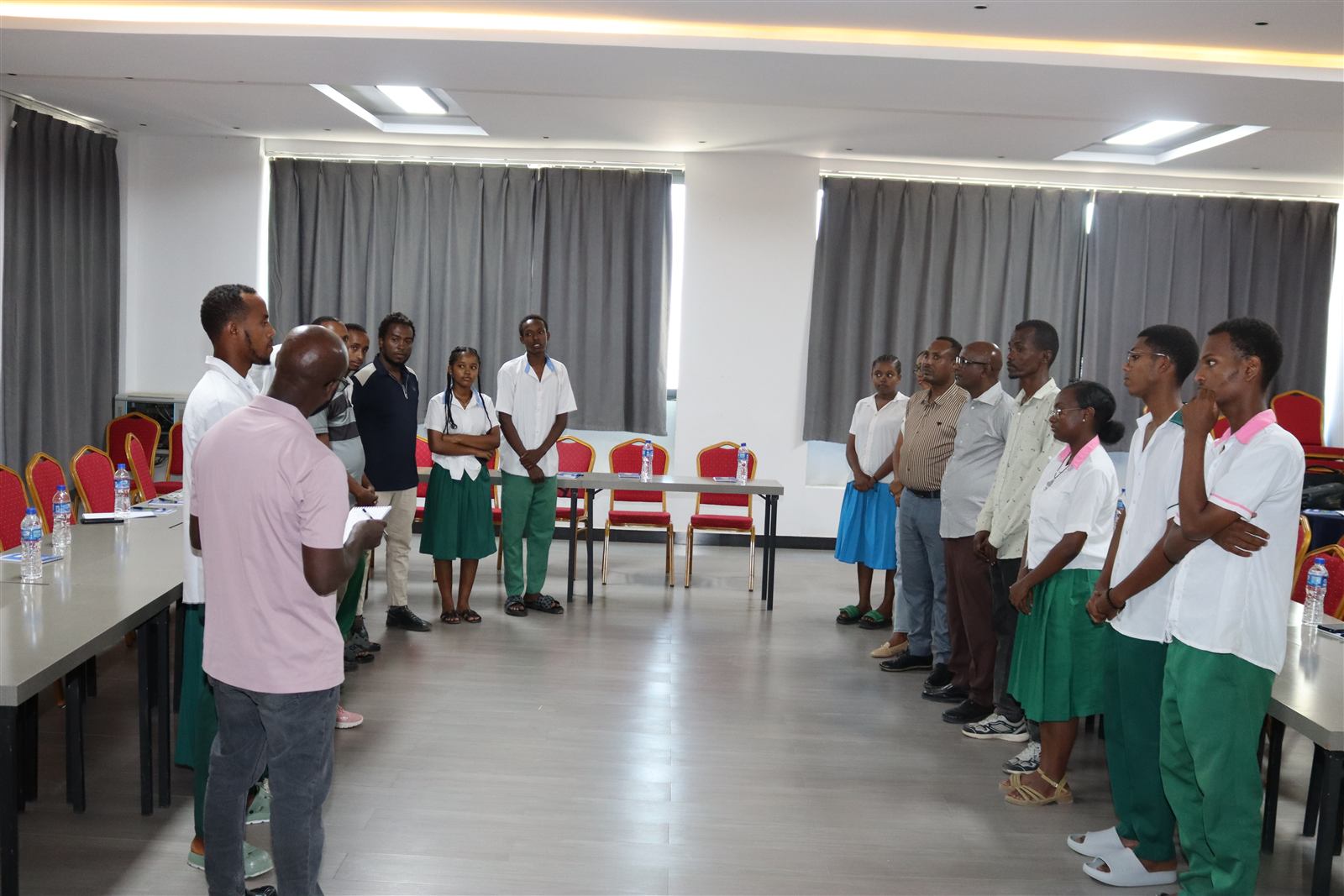 Students in school uniform in a peace-club dialogue circle, June 2026