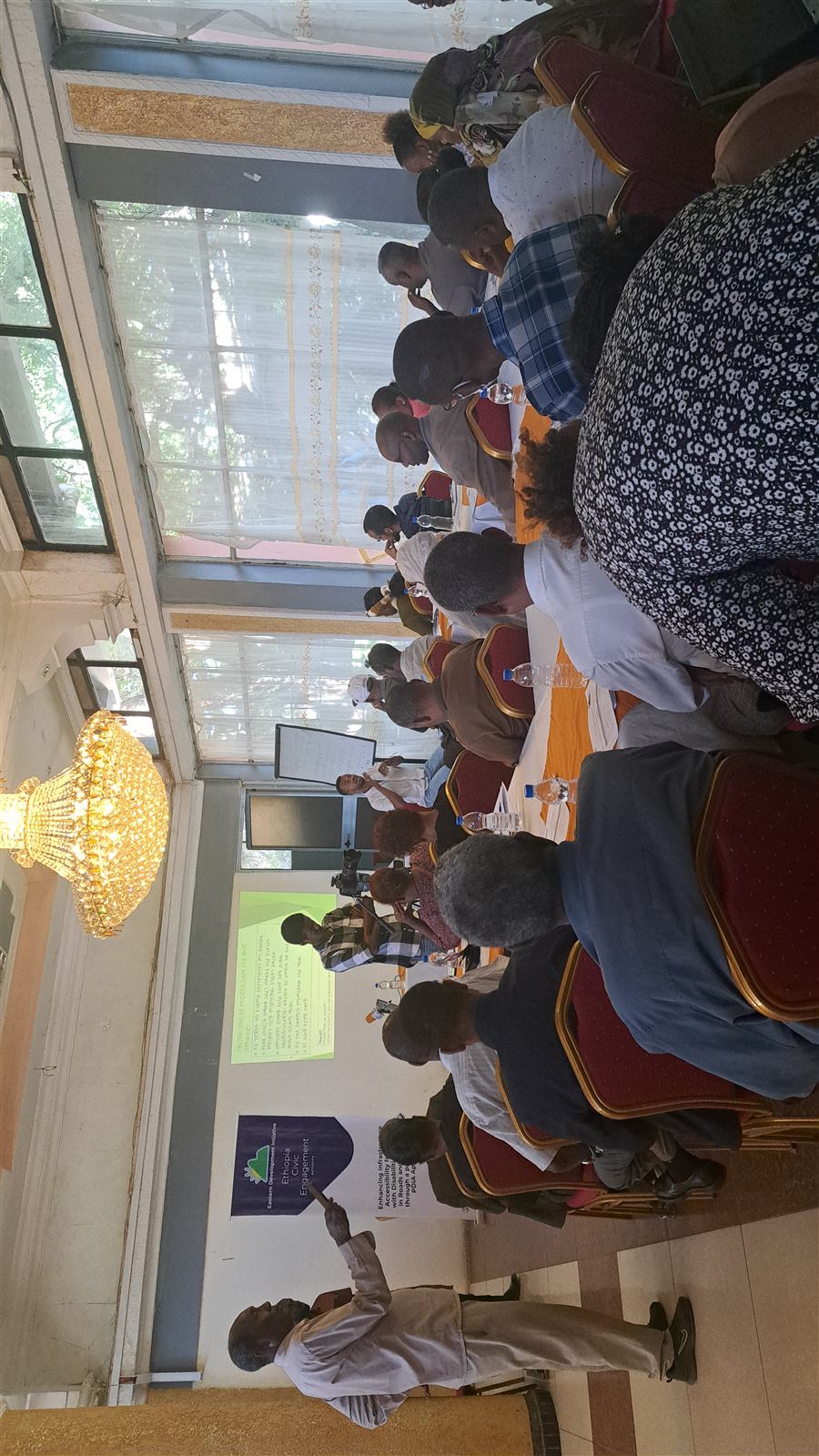 Wider view of the kickoff session with a projected Amharic slide and EDI civic engagement banner