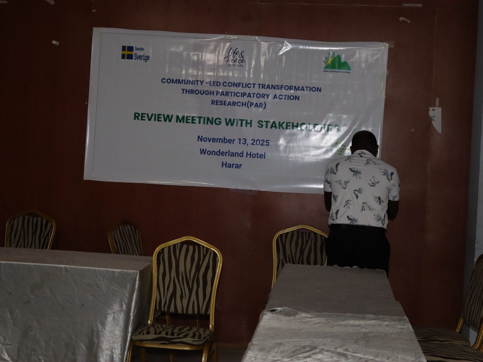 Clear shot of the full event banner naming Sweden, Life and Peace Institute, and EDI: Review Meeting with Stakeholders, November 13 2025, Wonderland Hotel, Harar