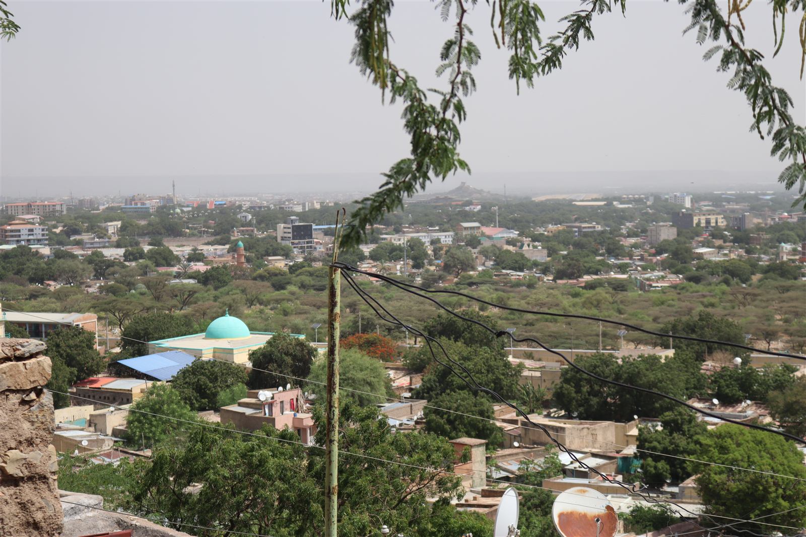 Hillside view over Dire Dawa with a turquoise-domed mosque and dense rooftops
